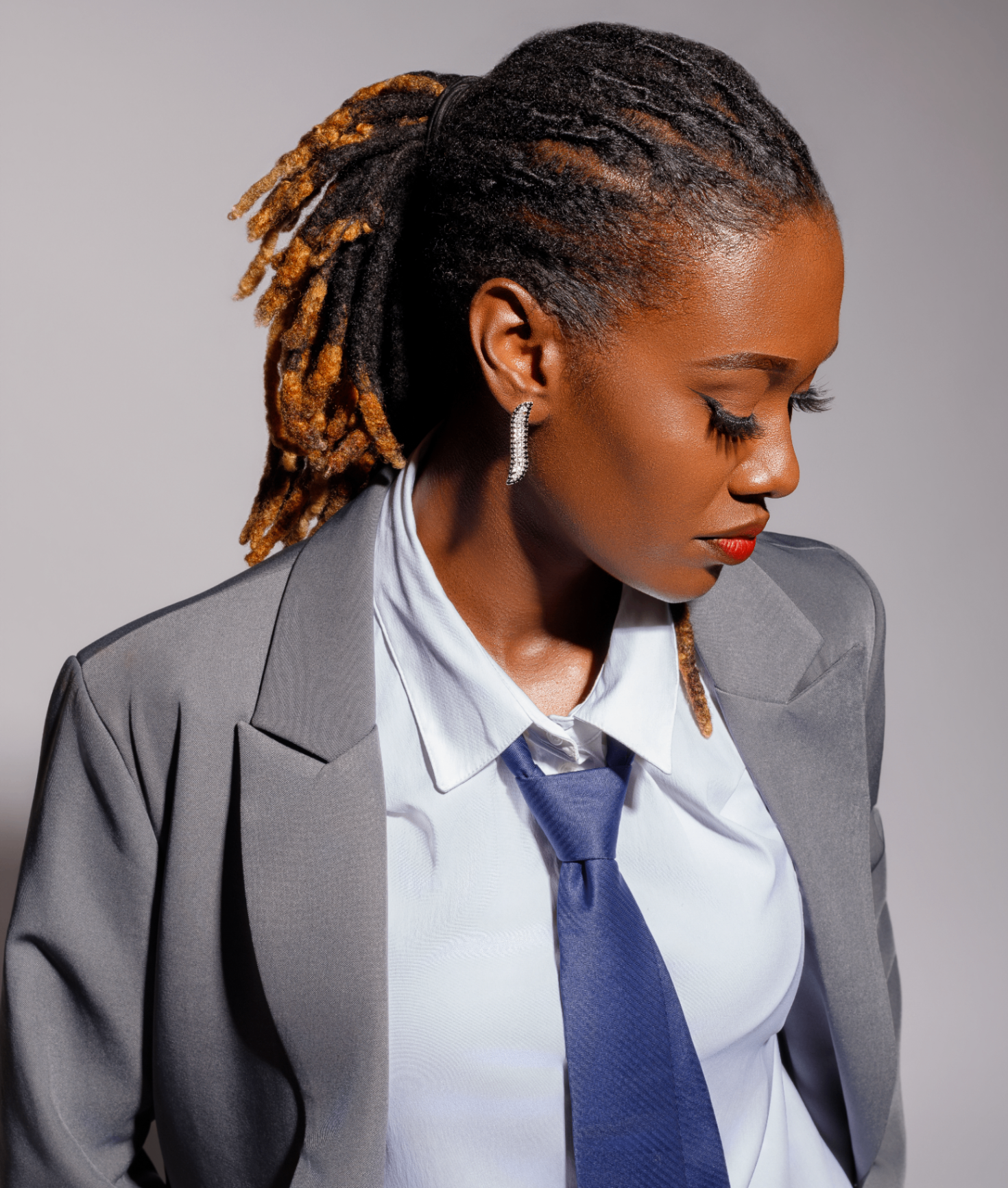 Editorial portrait, blazer and tie profile